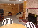Family room in lower walkout level. Fireplace, TV, game table, VCR, DVD player and leather rocker recliner.