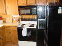Stove with mircrowave above.  Refrigerator has through the door ice and water.